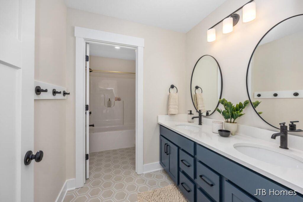 owner's bathroom with double vanity, two large mirrors and toilet closet