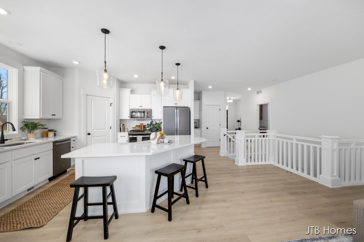 Water's Edge Condos South decorated kitchen with white walls and large kitchen island